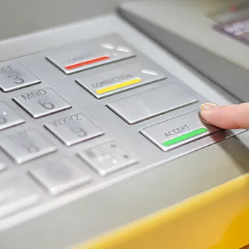 A man opening an LLC bank account via a cash machine