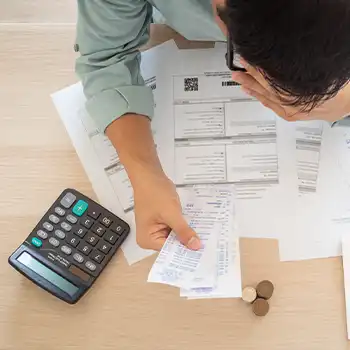 A person calculating expenses and debts