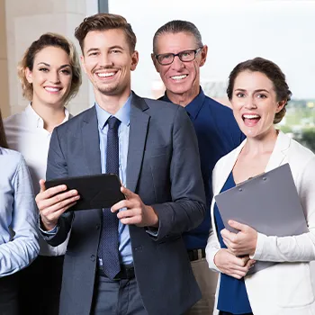 Workers smiling at the camera after discussion about the number of owners an llc can have