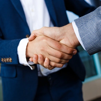 Close up image of two business person shaking hands