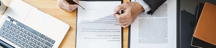 Top view of a busy person working on documents