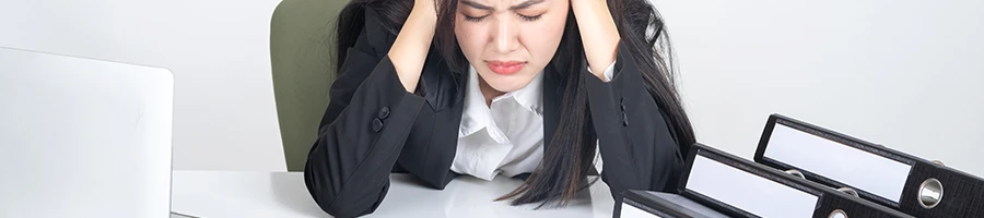 Frustrated and stressed woman on work table