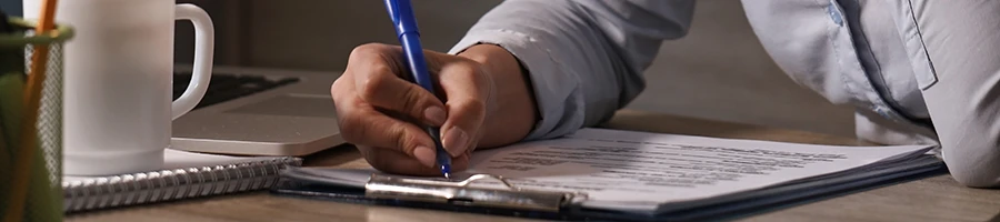 A man signing to transfer ownership of a Texas LLC