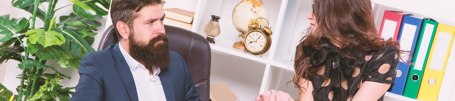 A man and a woman talking in an office