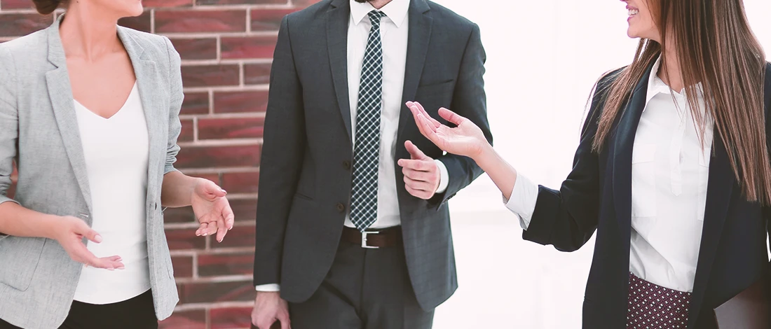 Professionals standing around while talking about best registered agent services