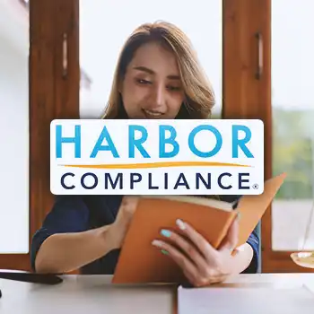 Harbor Compliance logo with a business person reading a notebook in the background