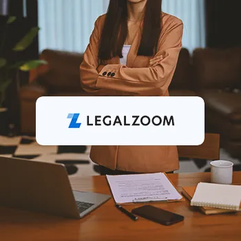 Legalzoom logo with an office worker posing in the background with a table full of paperwork