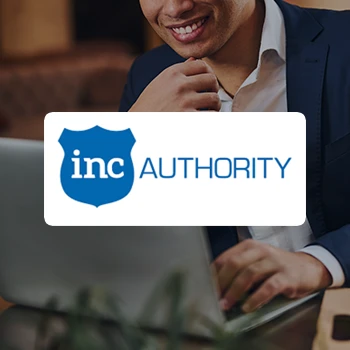 A smiling man using a laptop and a logo of Inc Authority