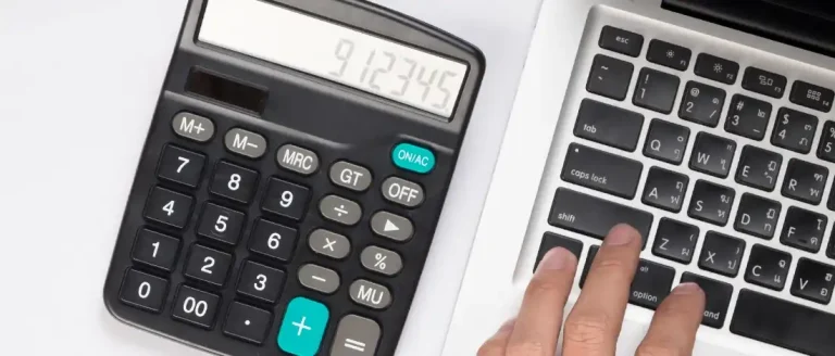 Calculating Arizona LLC taxes using calculator and laptop