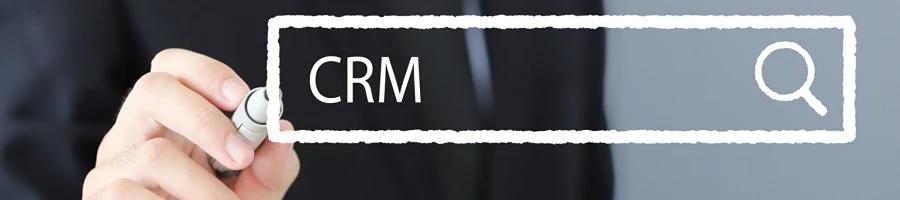 A person holding a marker pointing at CRM