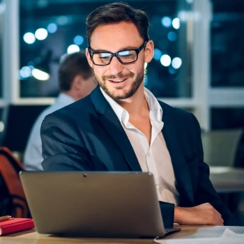 A happy business owner working on his laptop