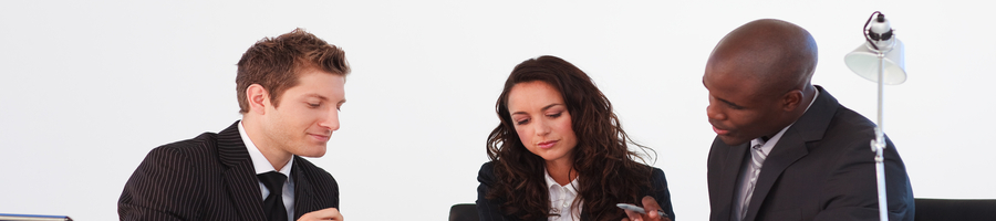 three people looking at a company laptop