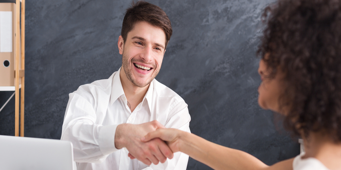 Lawyer and client shaking hands after signing the financing contract