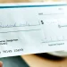 A man about to sign an LLC check