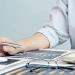 A business woman computing the LLC cost in Kansas